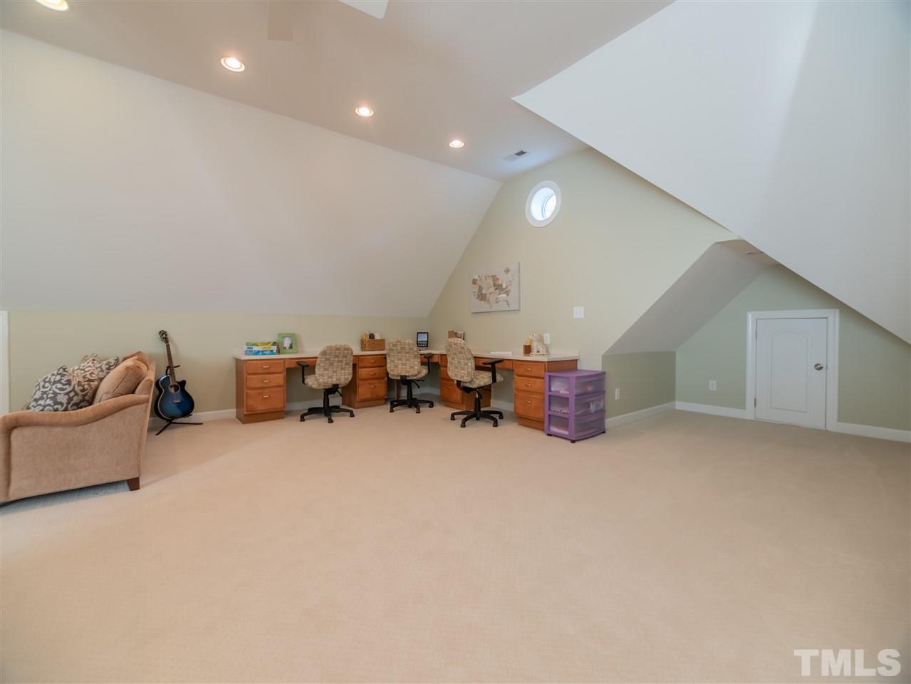 4016 White Chapel Way Raleigh, NC 27615 - Photo 23 of 30 Enormous bonus room with large dormer for natural light. The room also includes a built-in study area, separate craft/office area and full bath. A large walk-out attic area for additional storage is adjacent to this room.