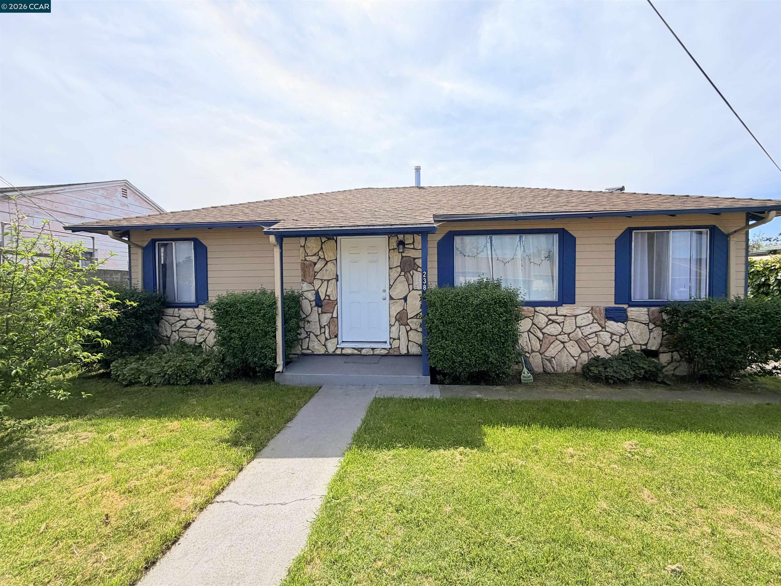 238 Fitzpatrick Road Oakland, CA 94603 - Photo 1 of 18 a front view of a house with a yard