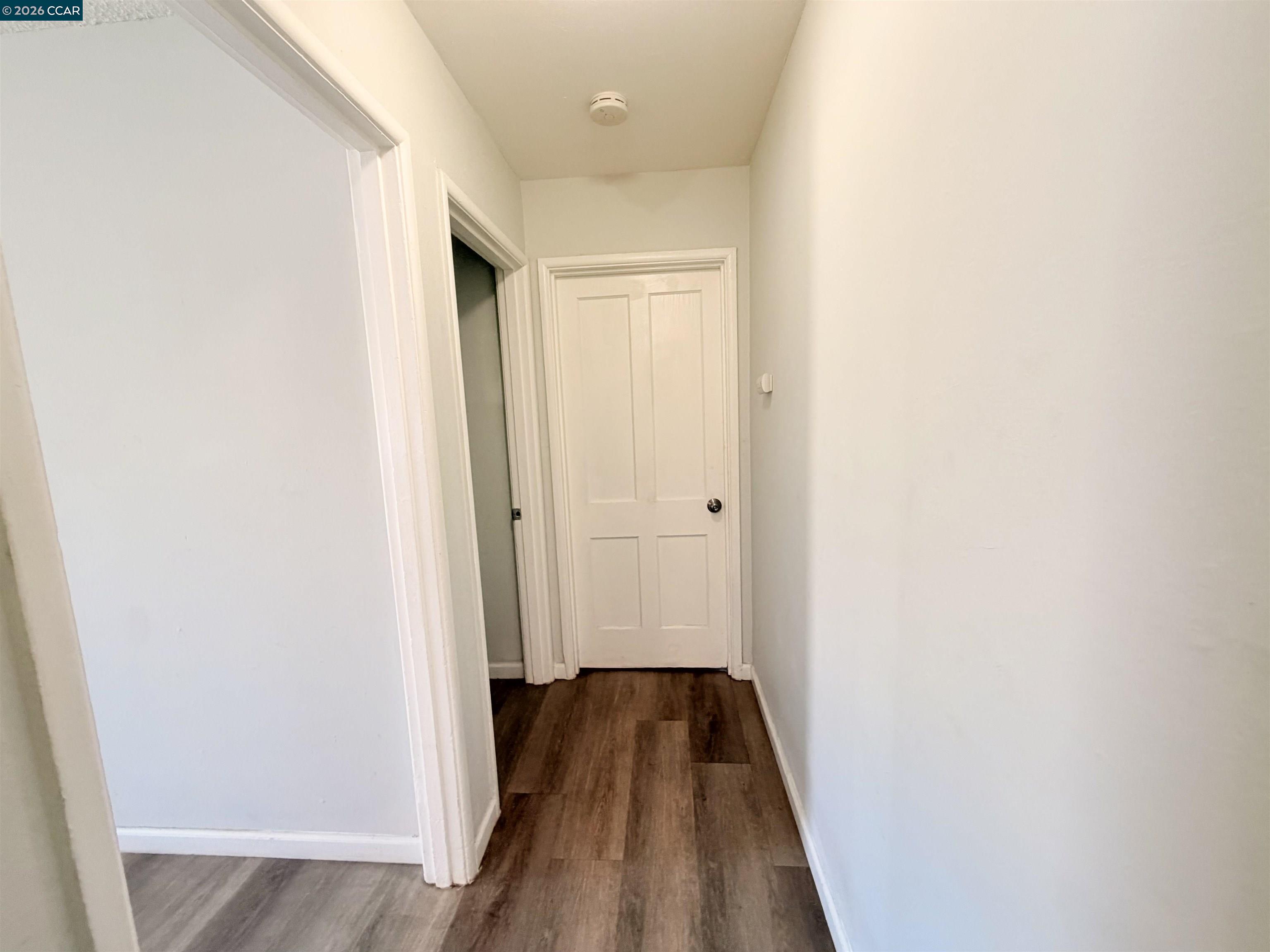 238 Fitzpatrick Road Oakland, CA 94603 - Photo 12 of 18 a view of a hallway with wooden floor and staircase