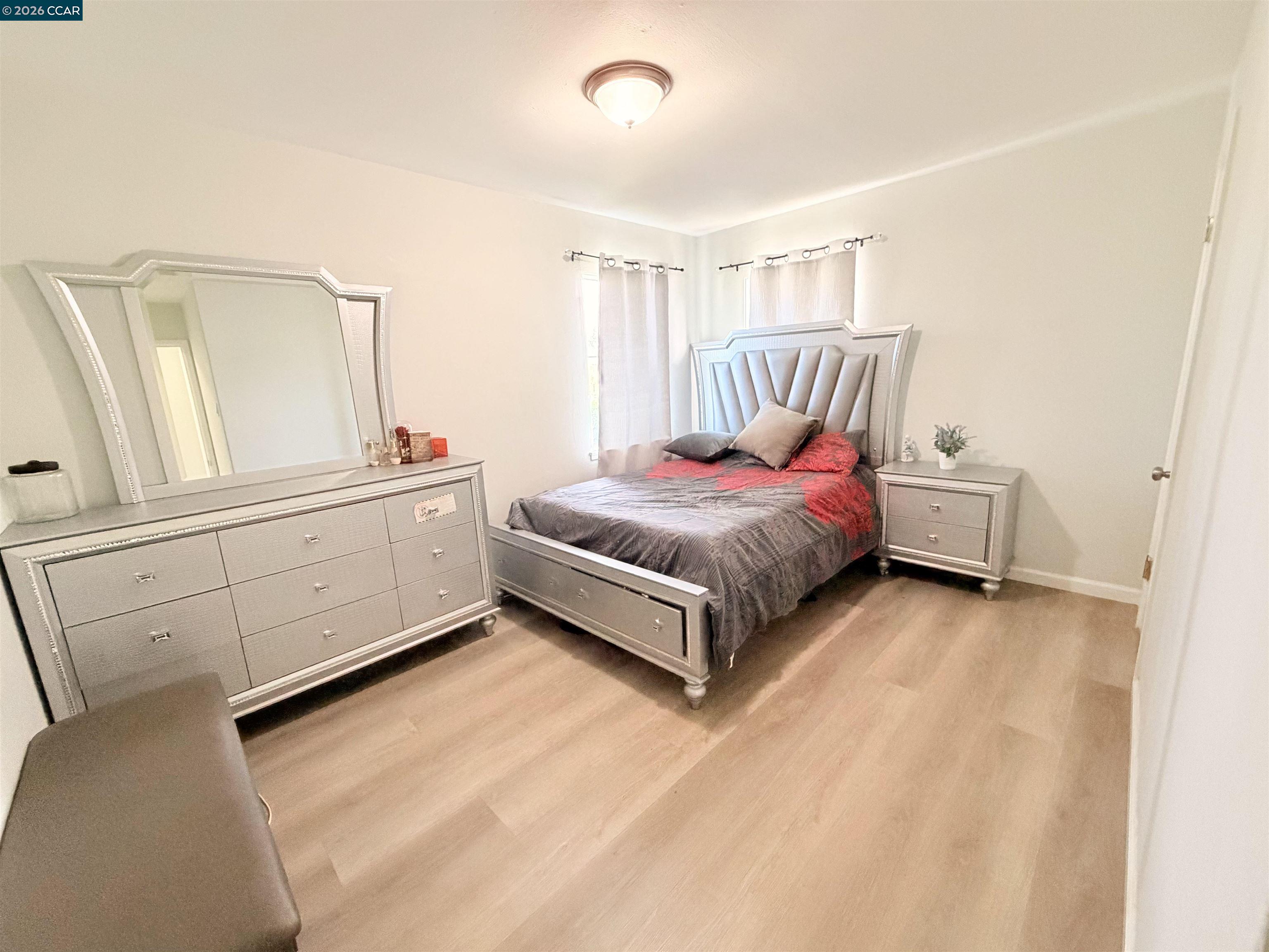 238 Fitzpatrick Road Oakland, CA 94603 - Photo 13 of 18 a spacious bedroom with a bed and a cabinets