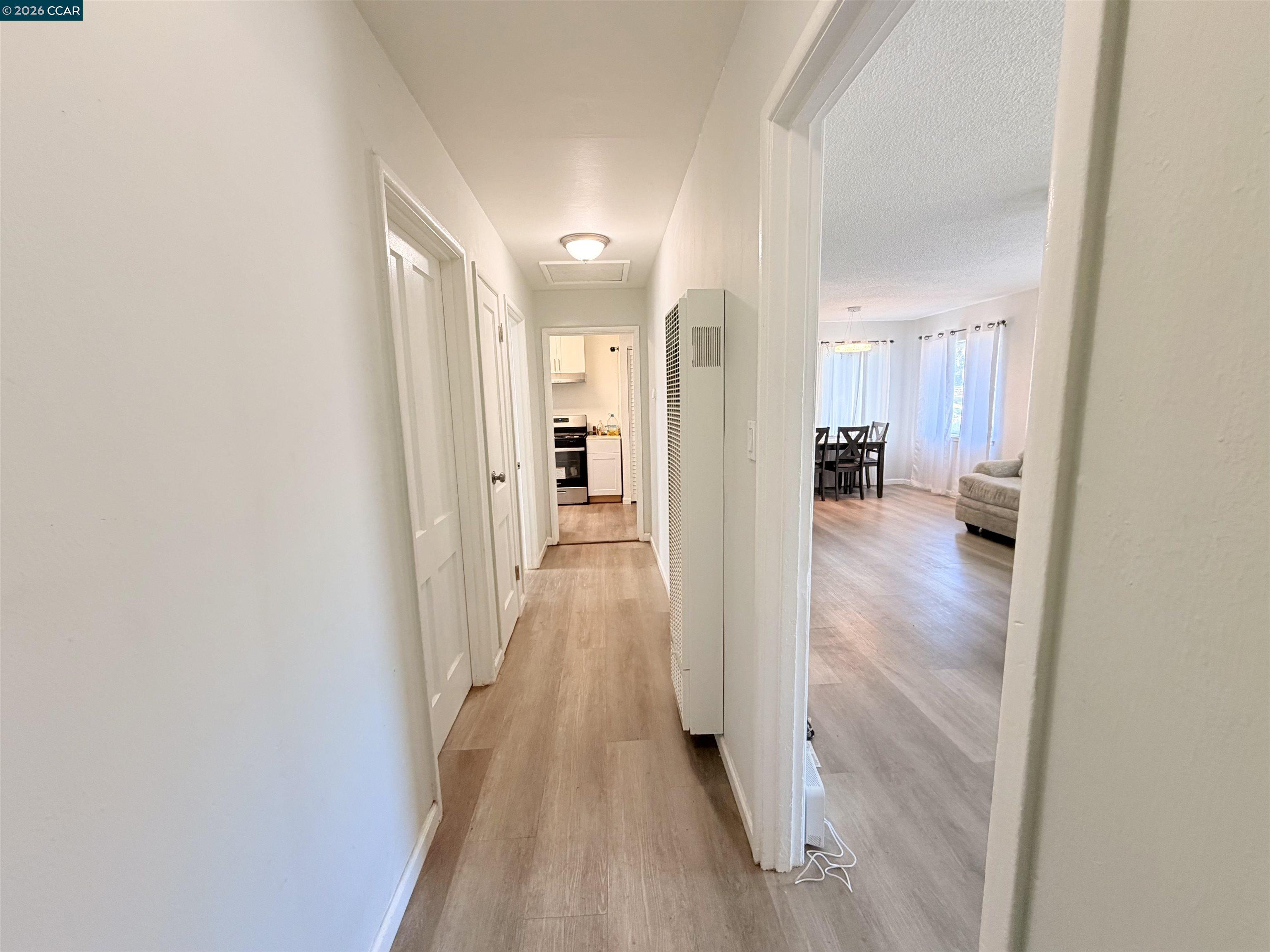238 Fitzpatrick Road Oakland, CA 94603 - Photo 15 of 18 a view of a hallway with wooden floor