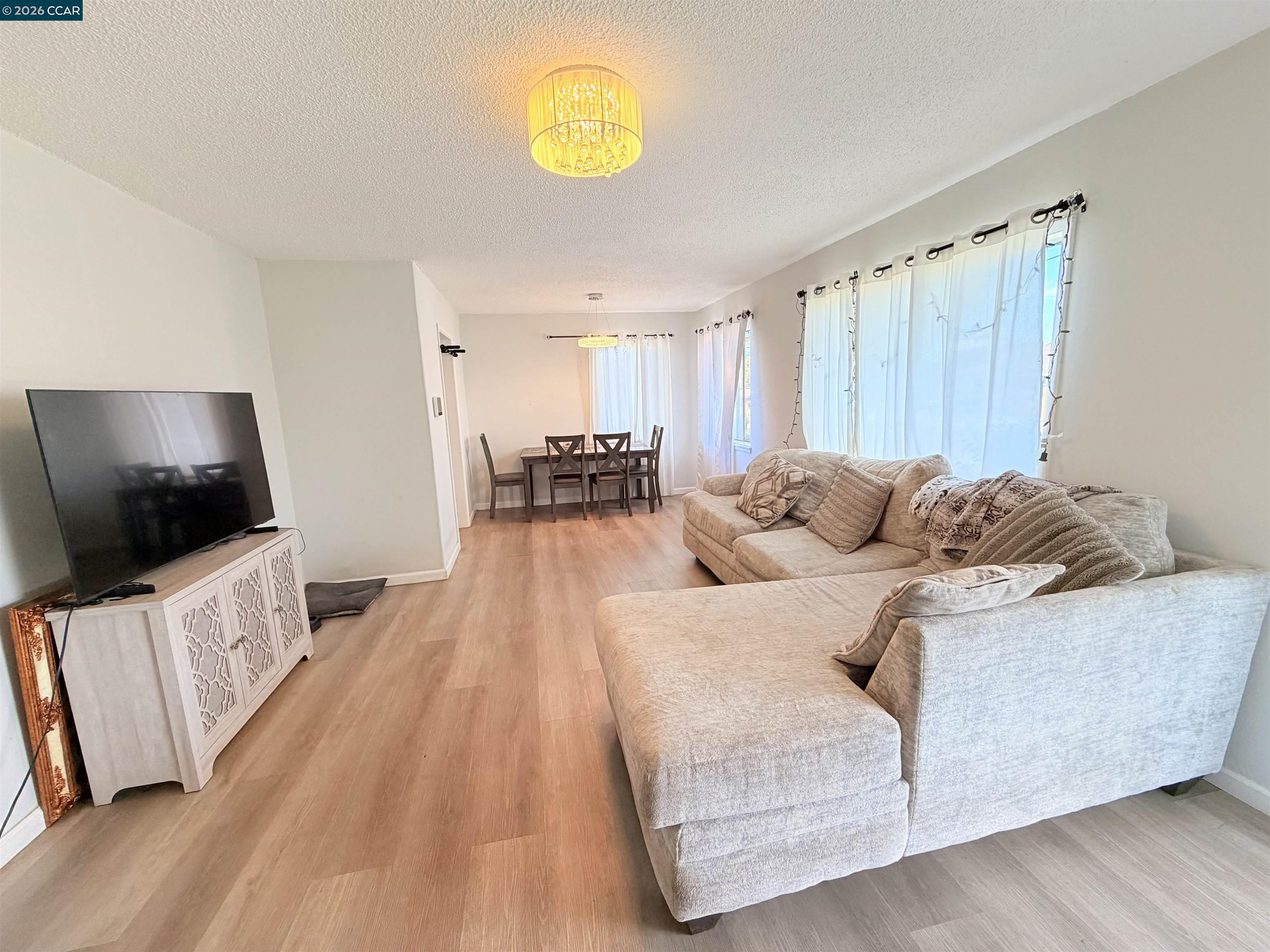 238 Fitzpatrick Road Oakland, CA 94603 - Photo 2 of 18 a living room with furniture and a flat screen tv