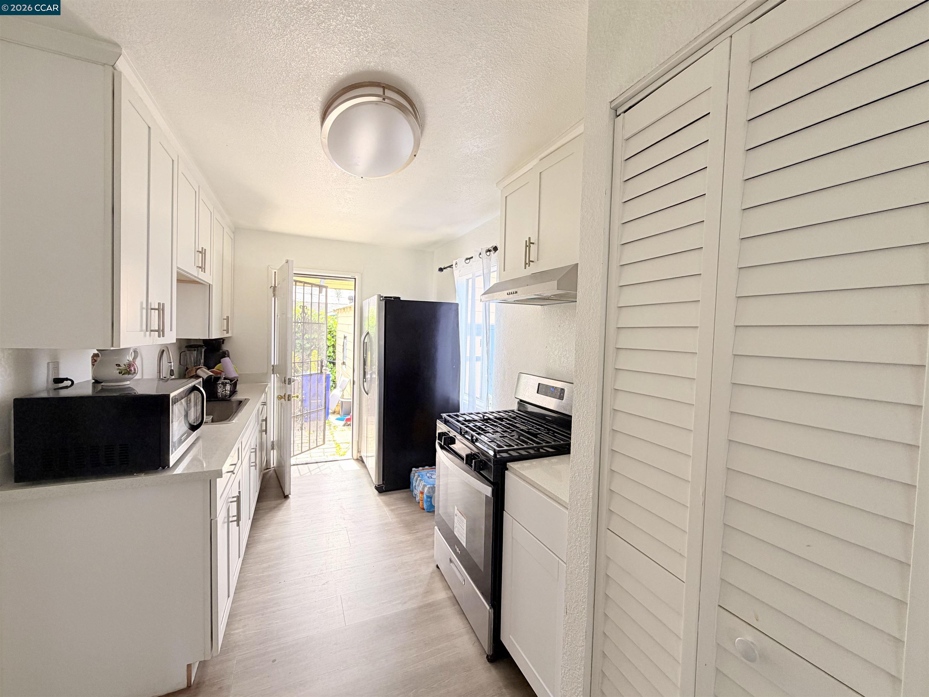 238 Fitzpatrick Road Oakland, CA 94603 - Photo 6 of 18 a kitchen with stainless steel appliances kitchen island granite countertop a stove and a refrigerator