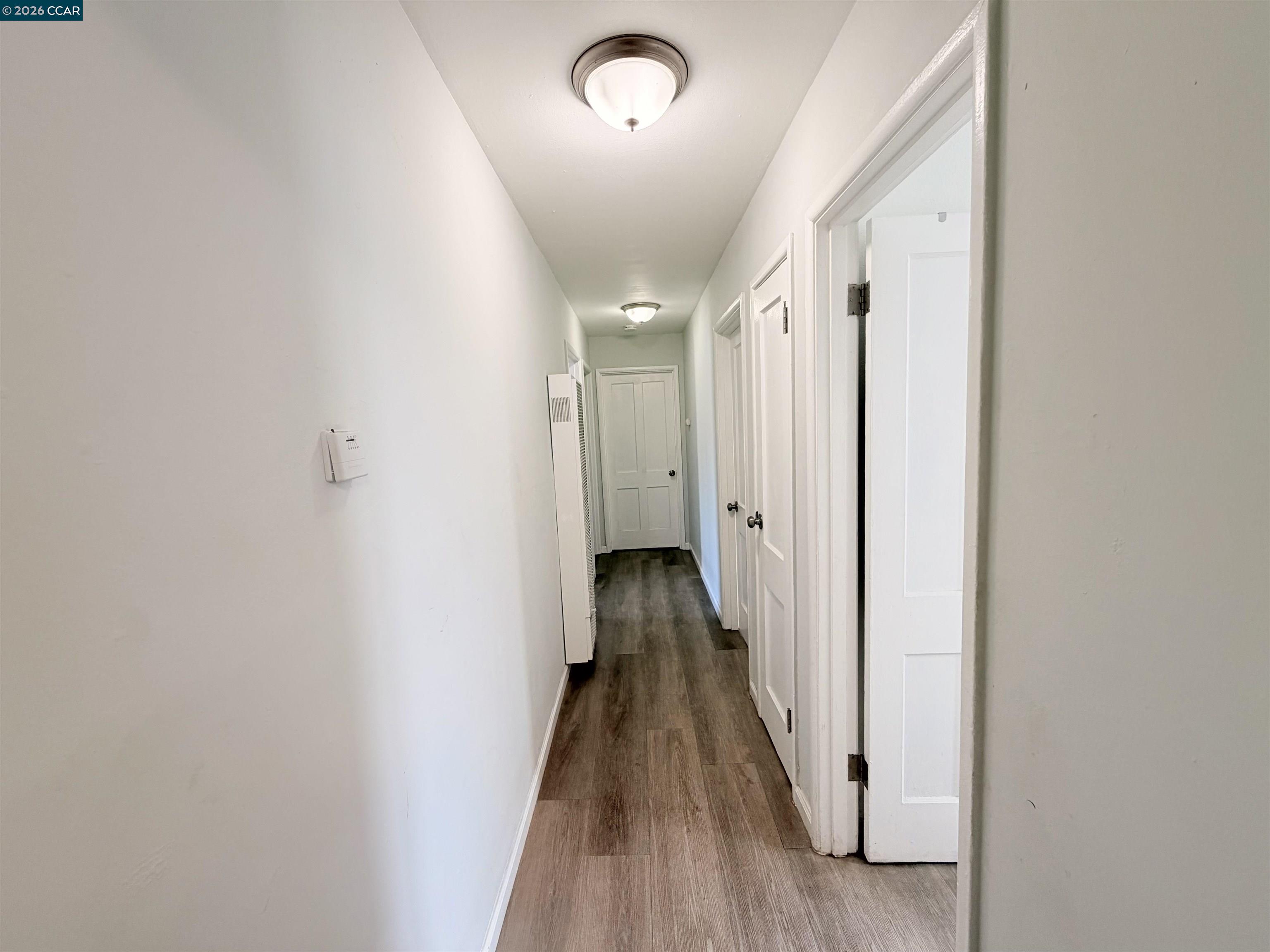 238 Fitzpatrick Road Oakland, CA 94603 - Photo 10 of 18 a view of a hallway with wooden floor