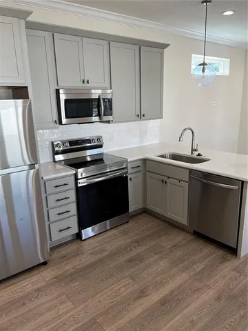 a kitchen with stainless steel appliances granite countertop a sink and stove top oven