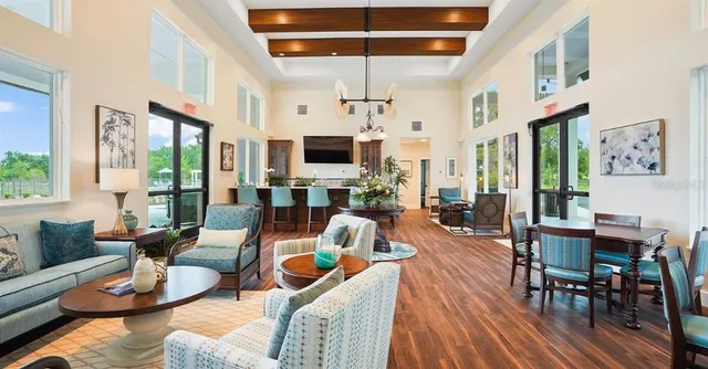 a living room with furniture a fireplace and a dining table with wooden floor