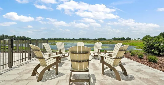 a view of a lake with furniture