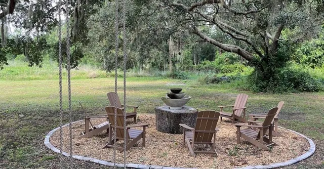 a view of a table and chairs in backyard