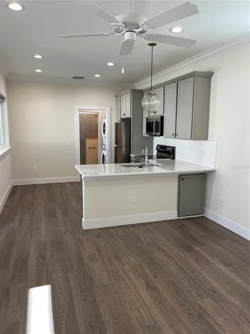a large kitchen with kitchen island a stove a sink and a refrigerator