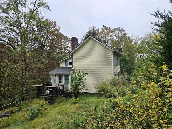 a view of backyard of house with green space