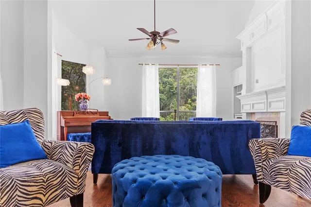a view of a dining room with furniture a chandelier and wooden floor
