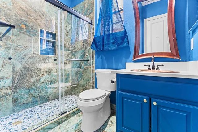 a bedroom with furniture and a large window