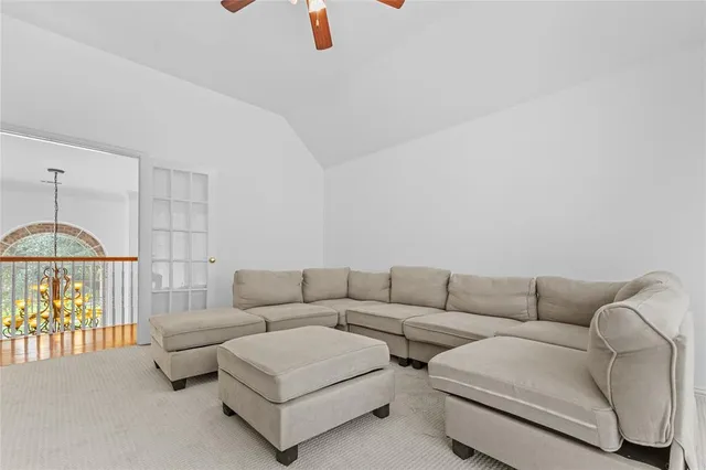 a living room with couches and large window with rug