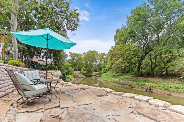 a front view of a house with a yard table and chairs