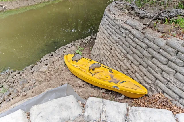 a view of patio with chairs and table under an umbrella