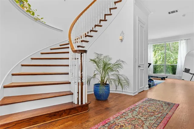 a view of entryway and hall with wooden floor