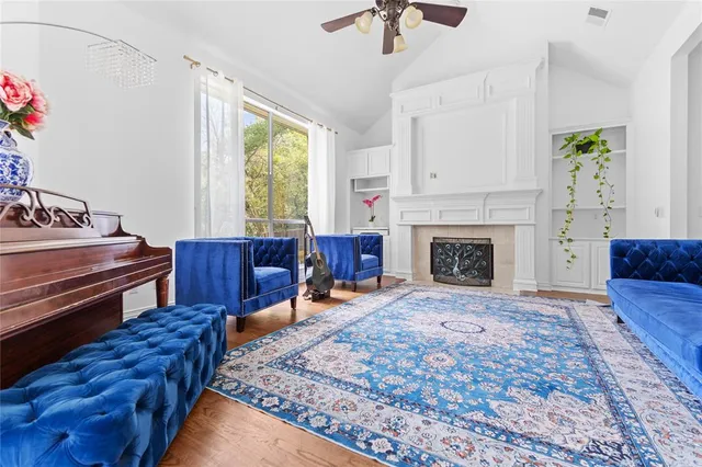 a living room with furniture fireplace and window