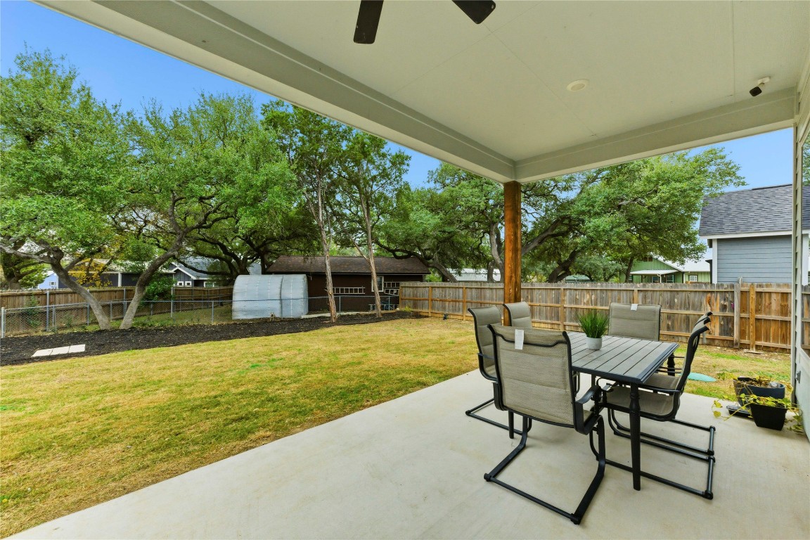 184 Granite Road Spring Branch, TX 78070 - Photo 22 of 27 Fenced backyard with a patio, outdoor dining area, and ceiling fan
