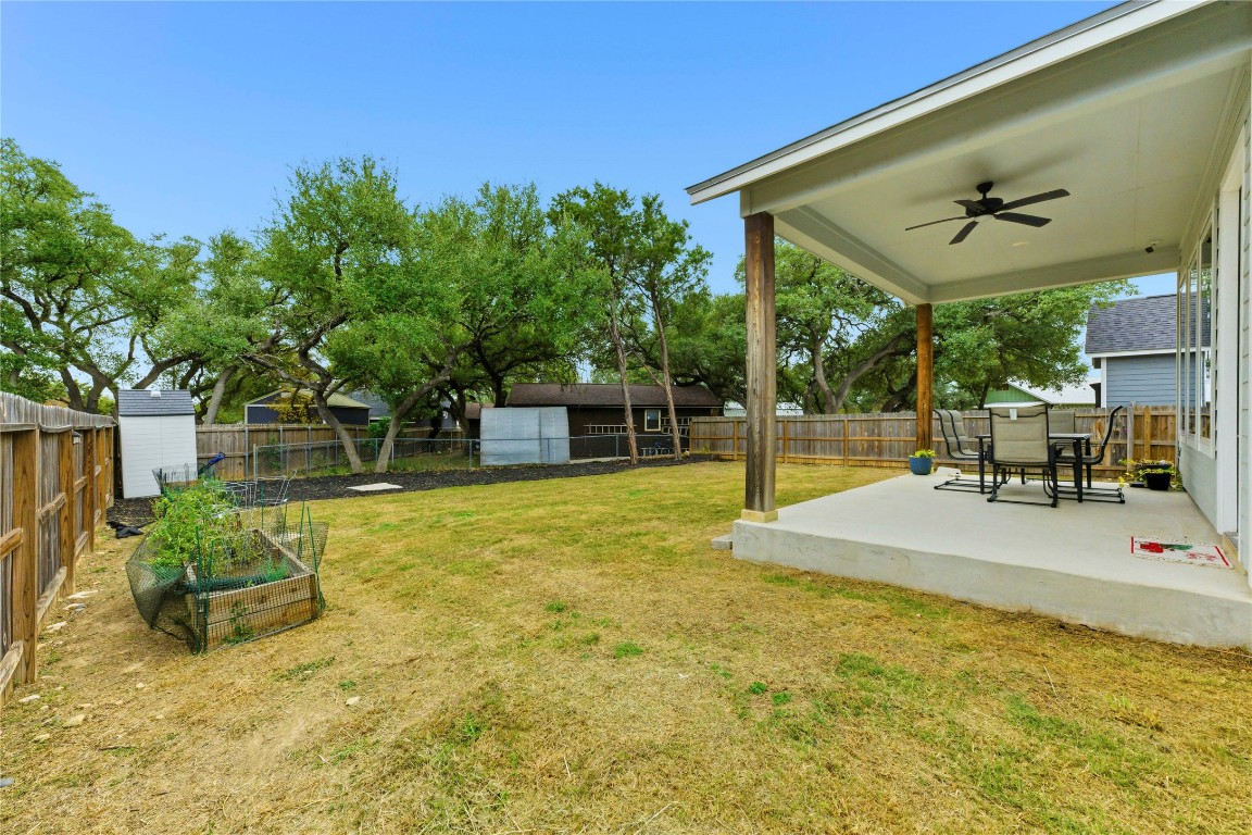 184 Granite Road Spring Branch, TX 78070 - Photo 23 of 27 Fenced backyard featuring a ceiling fan, a patio area, a garden, and a storage unit