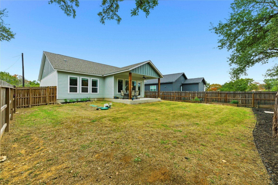 184 Granite Road Spring Branch, TX 78070 - Photo 25 of 27 Rear view of house with a patio, a fenced backyard, and a shingled roof