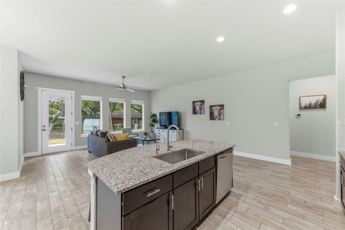 184 Granite Road Spring Branch, TX 78070 - Photo 8 of 27 Kitchen featuring dark brown cabinets, light stone counters, wood finish floors, a ceiling fan, and recessed lighting