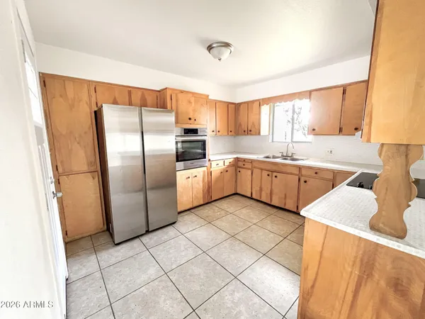a kitchen with a sink window and cabinets