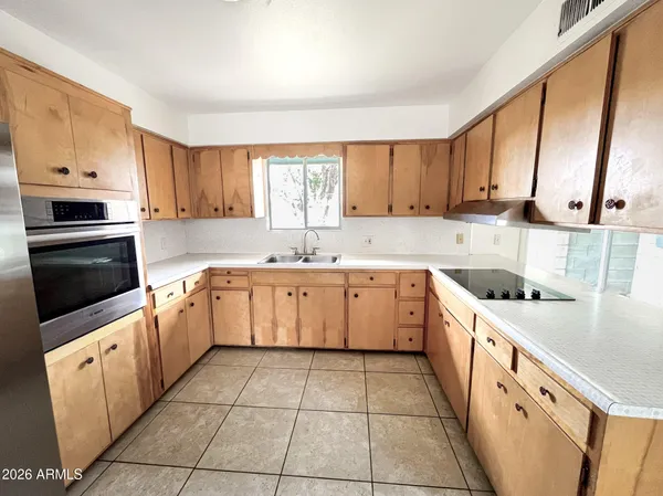 a kitchen with stainless steel appliances a refrigerator sink and cabinets