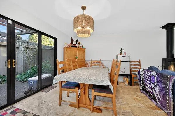 a dining room with furniture a rug and a chandelier