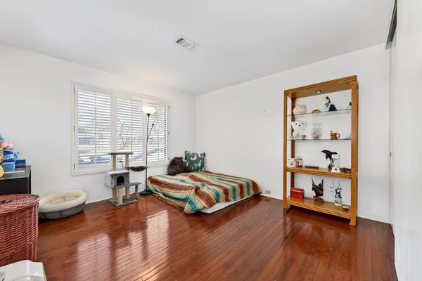 a bedroom with furniture and a wooden floor