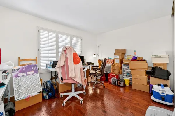 a view of a workspace with furniture and a window