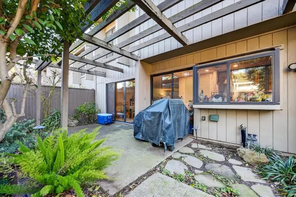 a view of a house with backyard and patio