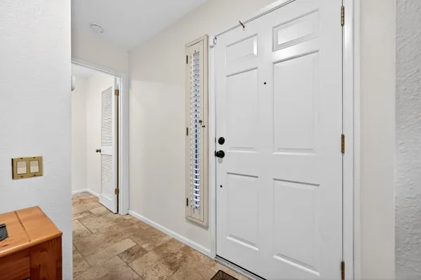a view of a bedroom with wooden floor