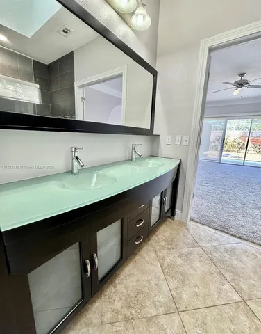 a spacious bathroom with a tub sink shower and mirror