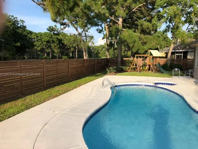 a large white tub sitting in front of a glass door