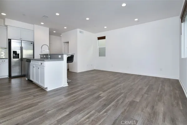 a kitchen with stainless steel appliances granite countertop a stove and a refrigerator
