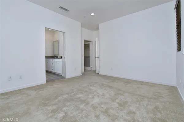 a bathroom with a granite countertop sink mirror and cabinets