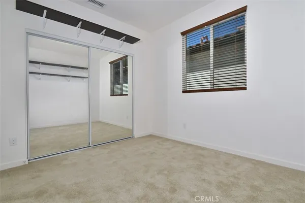 a view of a patio with table and chairs and potted plants