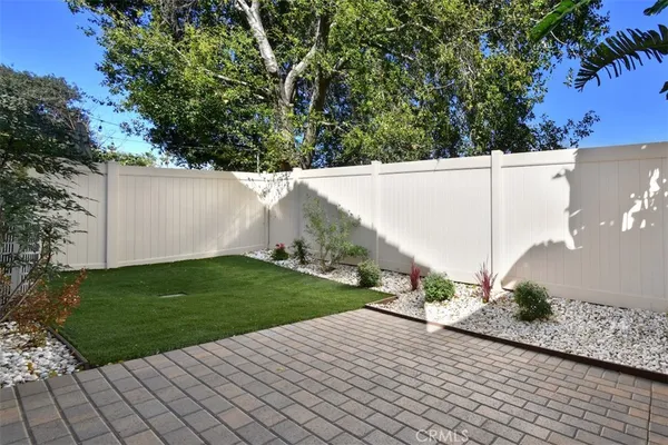 a view of a yard with wooden fence