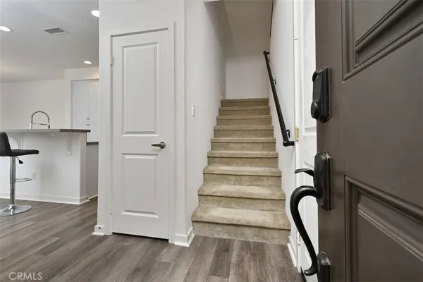 a view of entryway with wooden floor and stairs