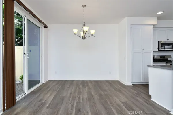 a view of kitchen with granite countertop cabinets and wooden floor