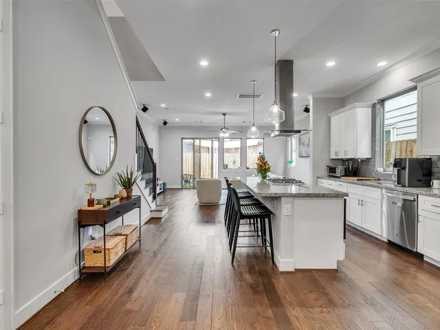 a kitchen with sink cabinets and wooden floor