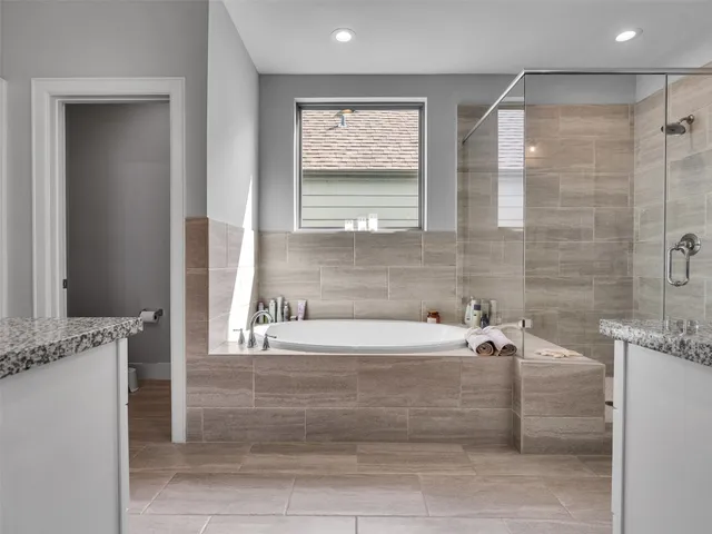 a bathroom with a bathtub and a shower