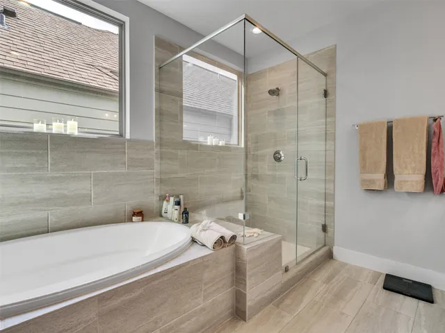 a bathroom with a bathtub and a shower