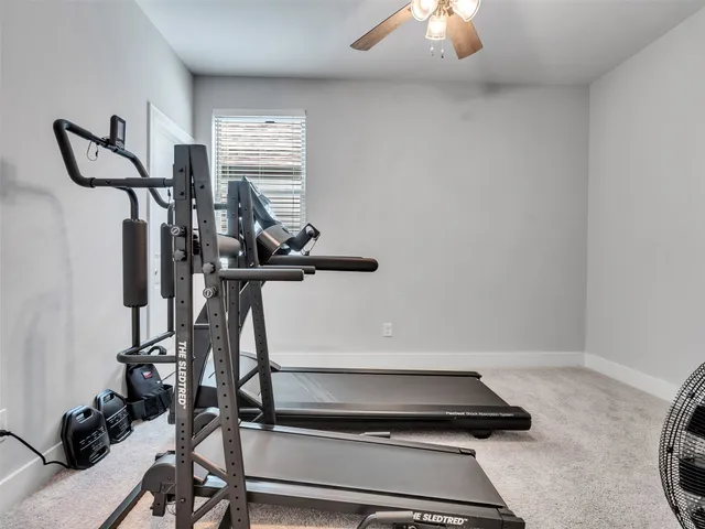 a room with gym equipment and a window