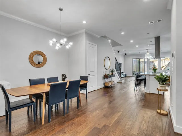 a view of a dining room with furniture and wooden floor