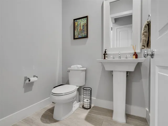 a bathroom with a sink toilet and a mirror