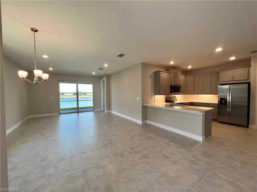 842 Enbrook Loop Naples, FL 34114 - Photo 5 of 23 a large kitchen with a large counter top stainless steel appliances and cabinets
