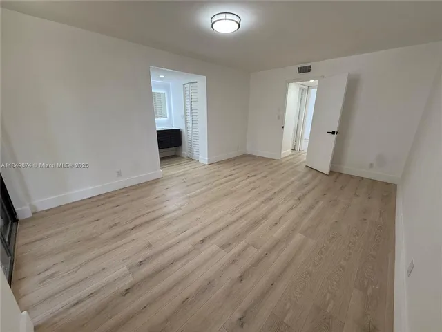 wooden floor and white cabinet in an empty room