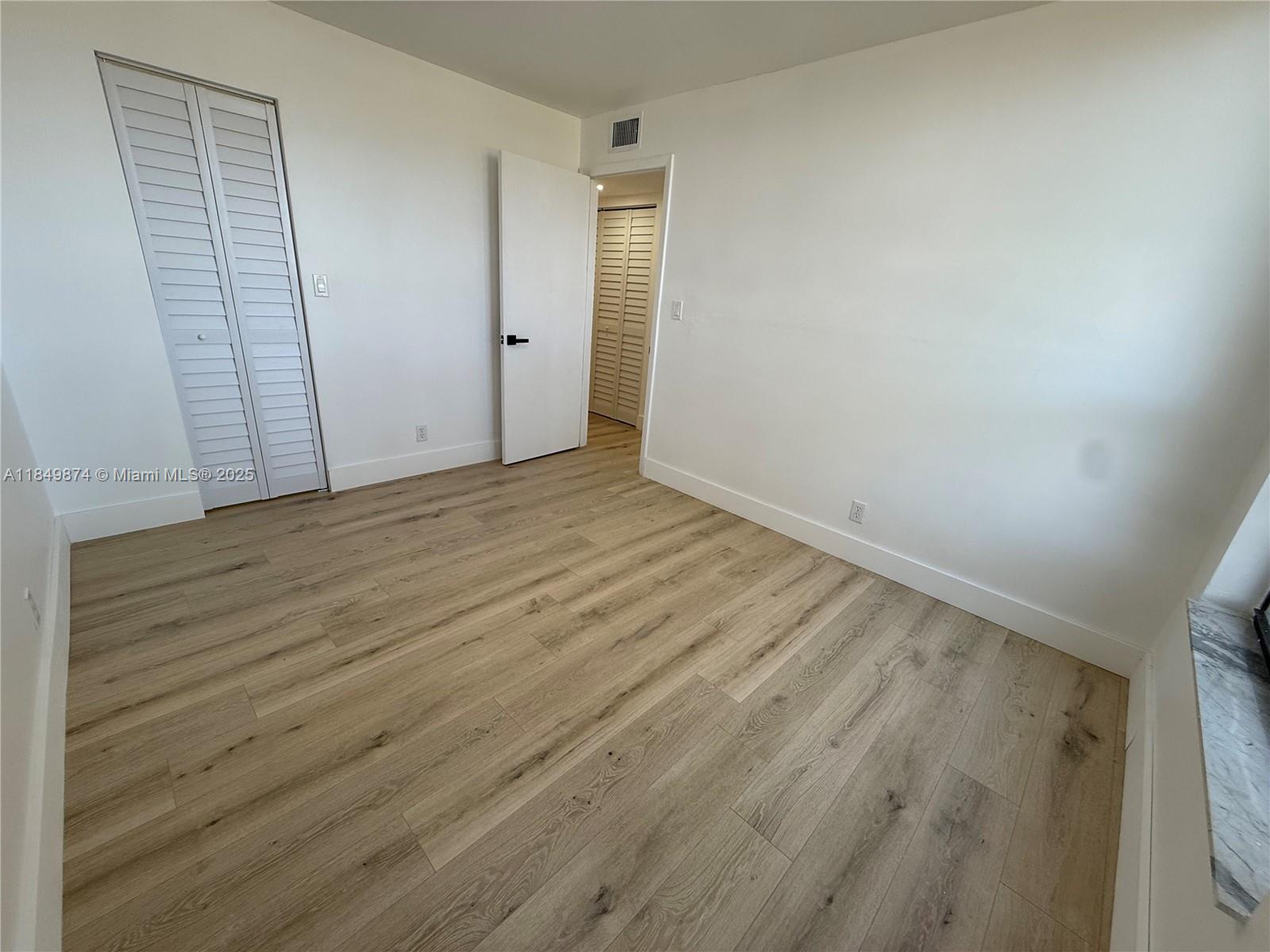 7950 West McNab Road, Unit 102 Tamarac, FL 33321 - Photo 19 of 34 wooden floor in an empty room
