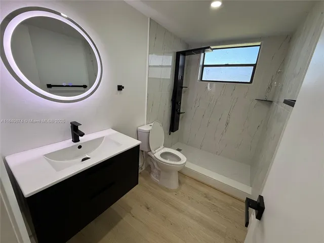 a bathroom with a toilet sink and a mirror